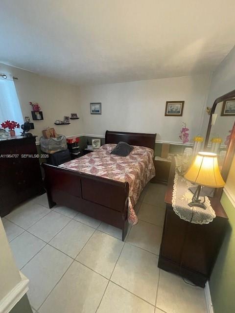 14250 Southwest 62nd Street, Unit 320 Miami, FL 33183 - Photo 9 of 14 a bed room with a bed and a chair