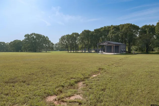 a balcony with outdoor seating and green space