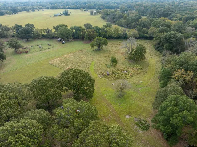 a view of a field with an ocean view