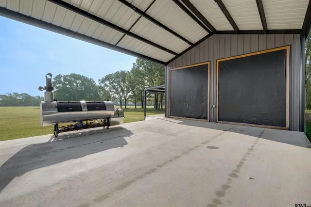 a view of a patio with a table and chairs