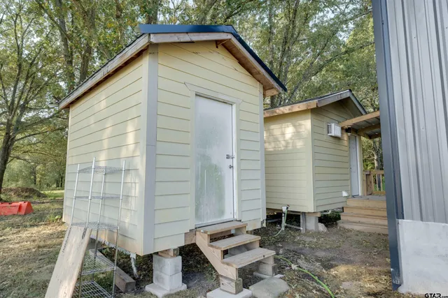 a view of a small house with backyard