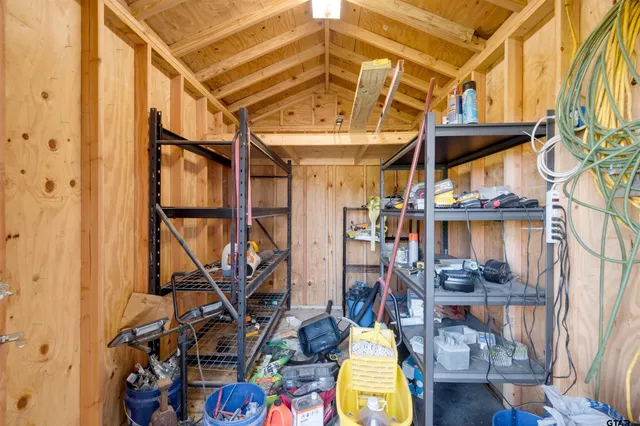 a view of a backyard with wooden fence