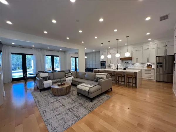 a view of a a dining room with furniture and wooden floor