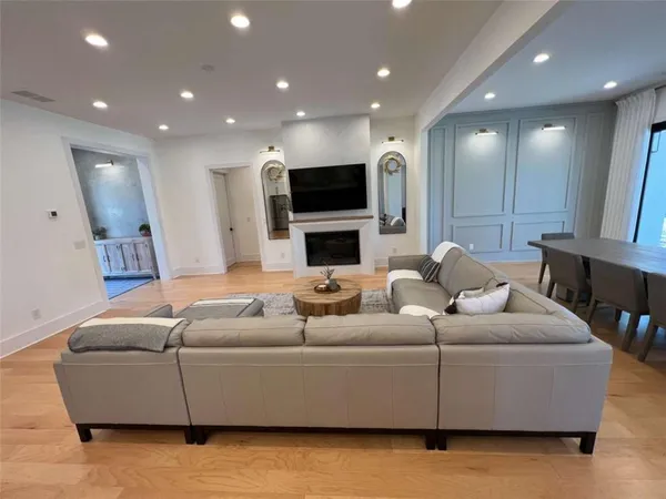 a spacious bedroom with a bed and a dresser