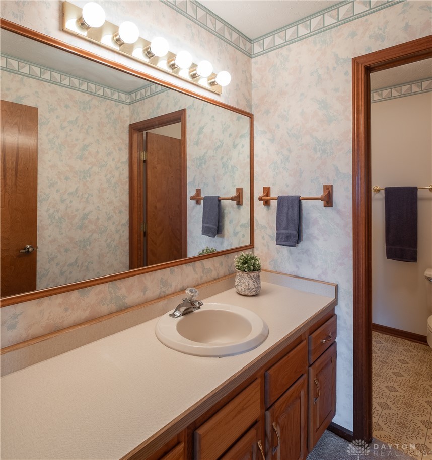 276 South Fairfield Road Bellbrook, OH 45305 - Photo 30 of 38 This bright bathroom features a spacious vanity, large mirror, and classic details.