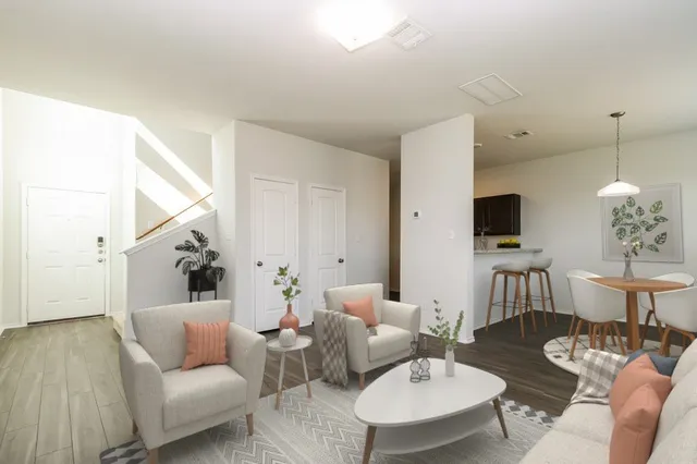 a living room with furniture and wooden floor