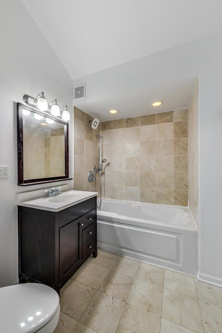 2035 West Rice Street Chicago, IL 60622 - Photo 13 of 27 a bathroom with a sink a toilet and bathtub