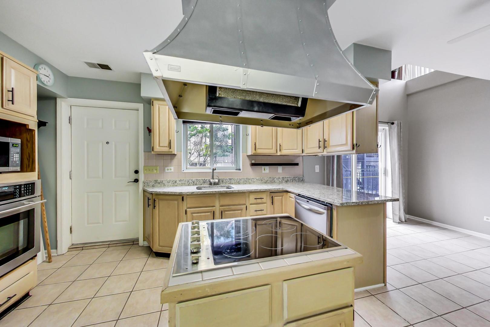 2035 West Rice Street Chicago, IL 60622 - Photo 20 of 27 a kitchen with stainless steel appliances granite countertop a sink and a stove