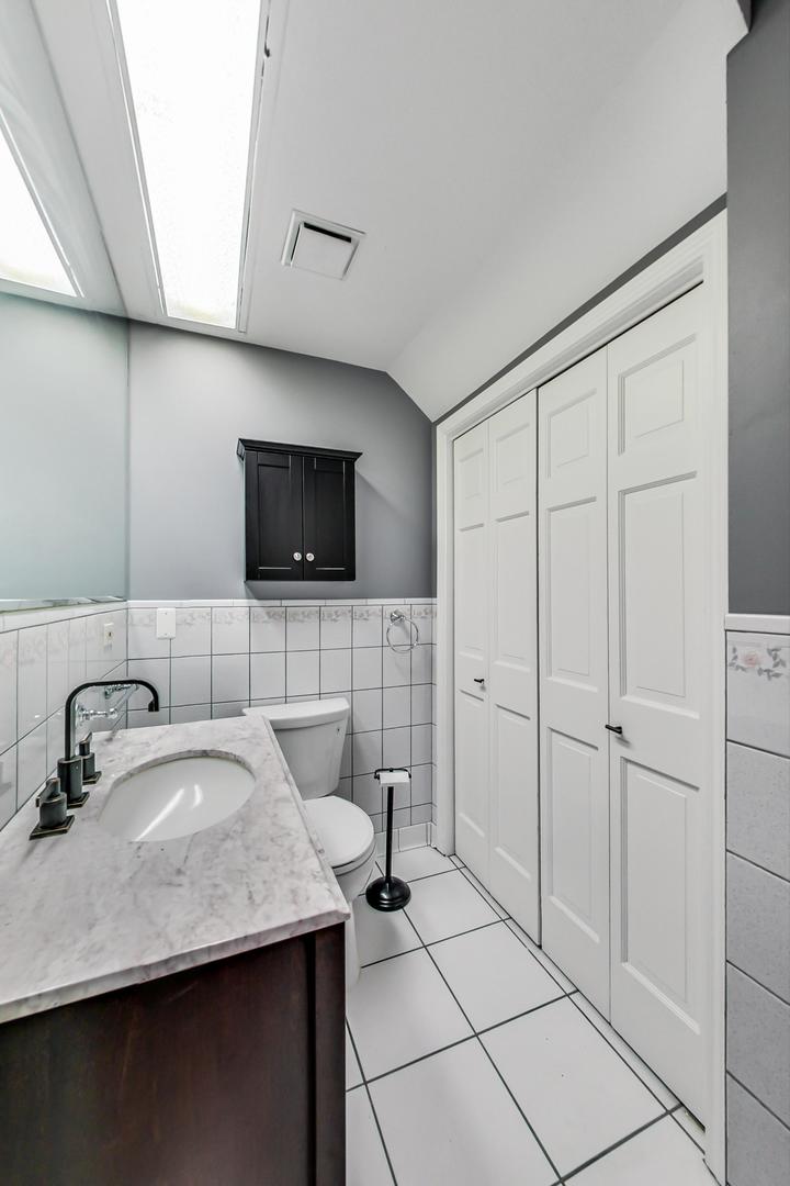 2035 West Rice Street Chicago, IL 60622 - Photo 22 of 27 a bathroom with a sink and a mirror