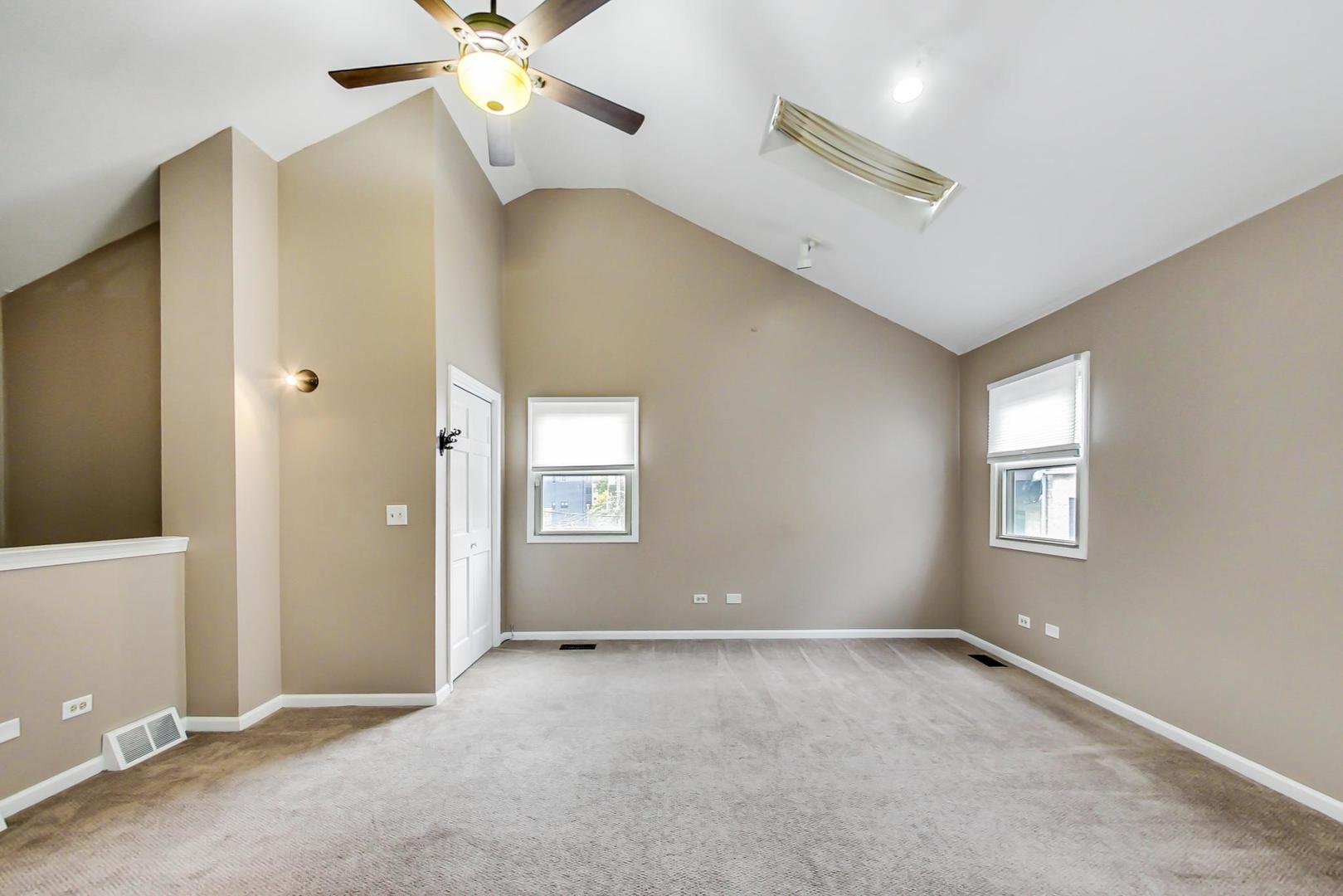 2035 West Rice Street Chicago, IL 60622 - Photo 25 of 27 an empty room with ceiling fan and window