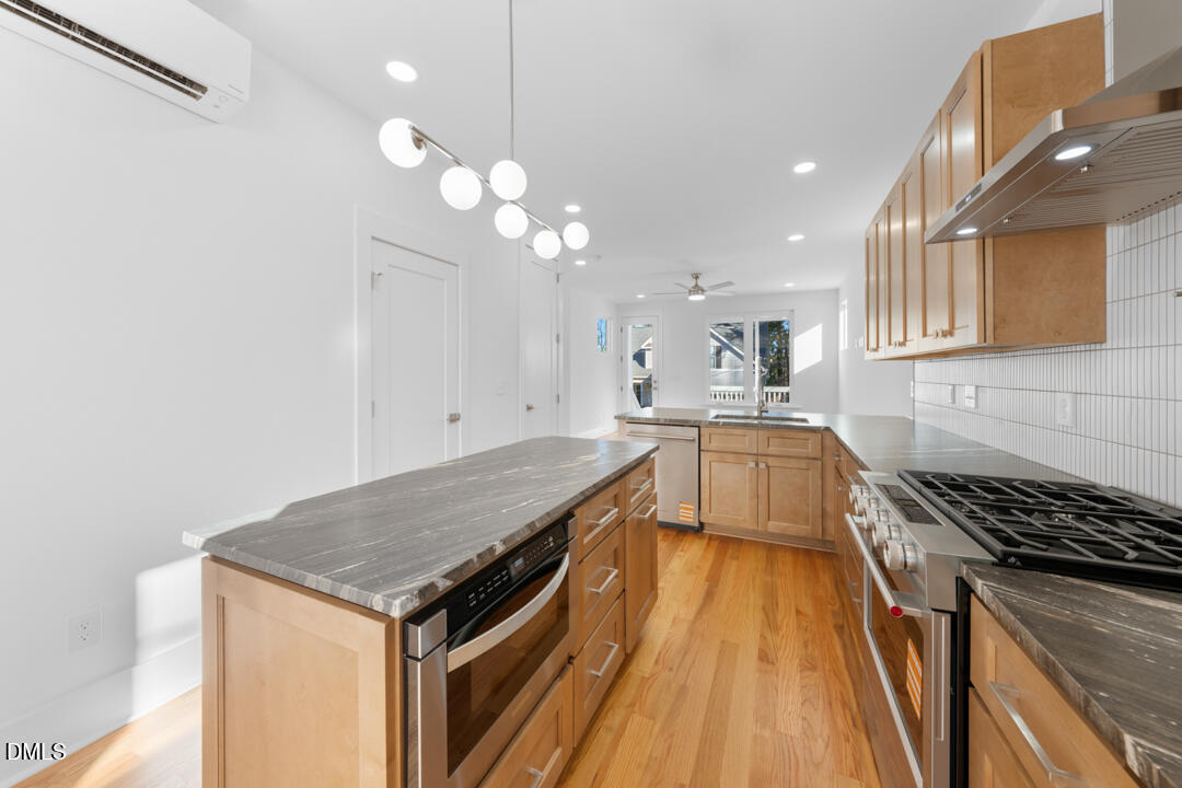 2530 West Wilson Street Durham, NC 27705 - Photo 20 of 49 a kitchen with cabinets and wooden floor