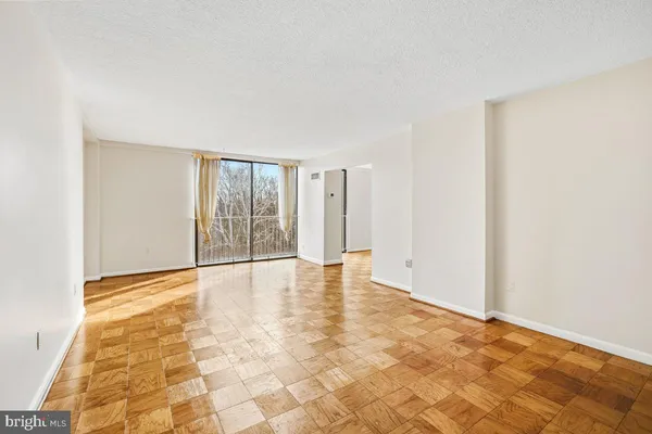 a view of an empty room with glass door