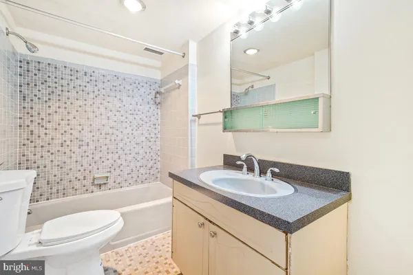 a bathroom with a sink toilet vanity and shower