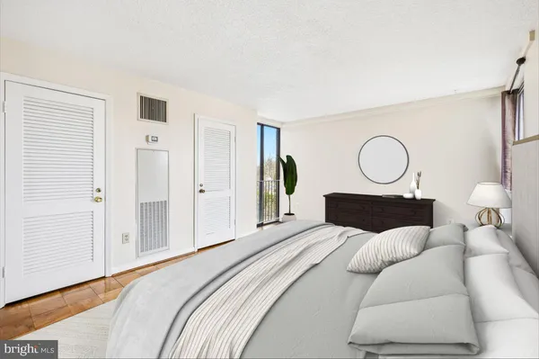 a bedroom with a large bed and a lamp