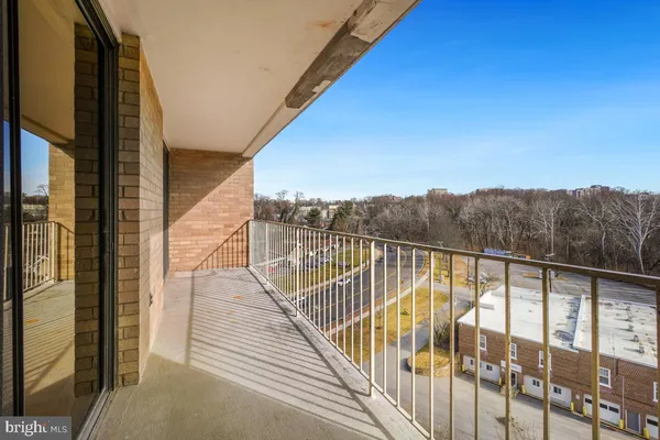 a view of balcony with mountain view and wooden floor
