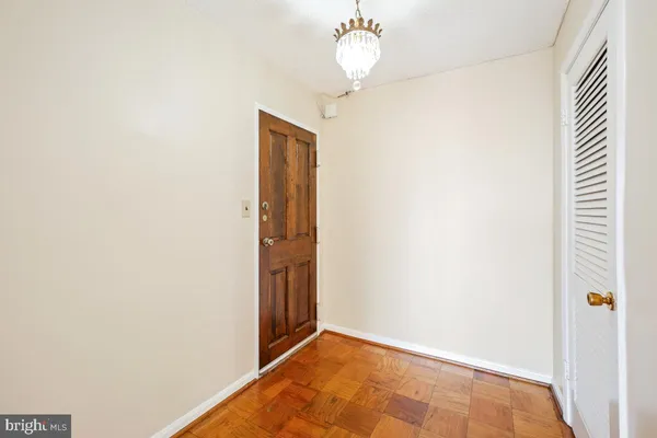 a view of a hallway with a chandelier