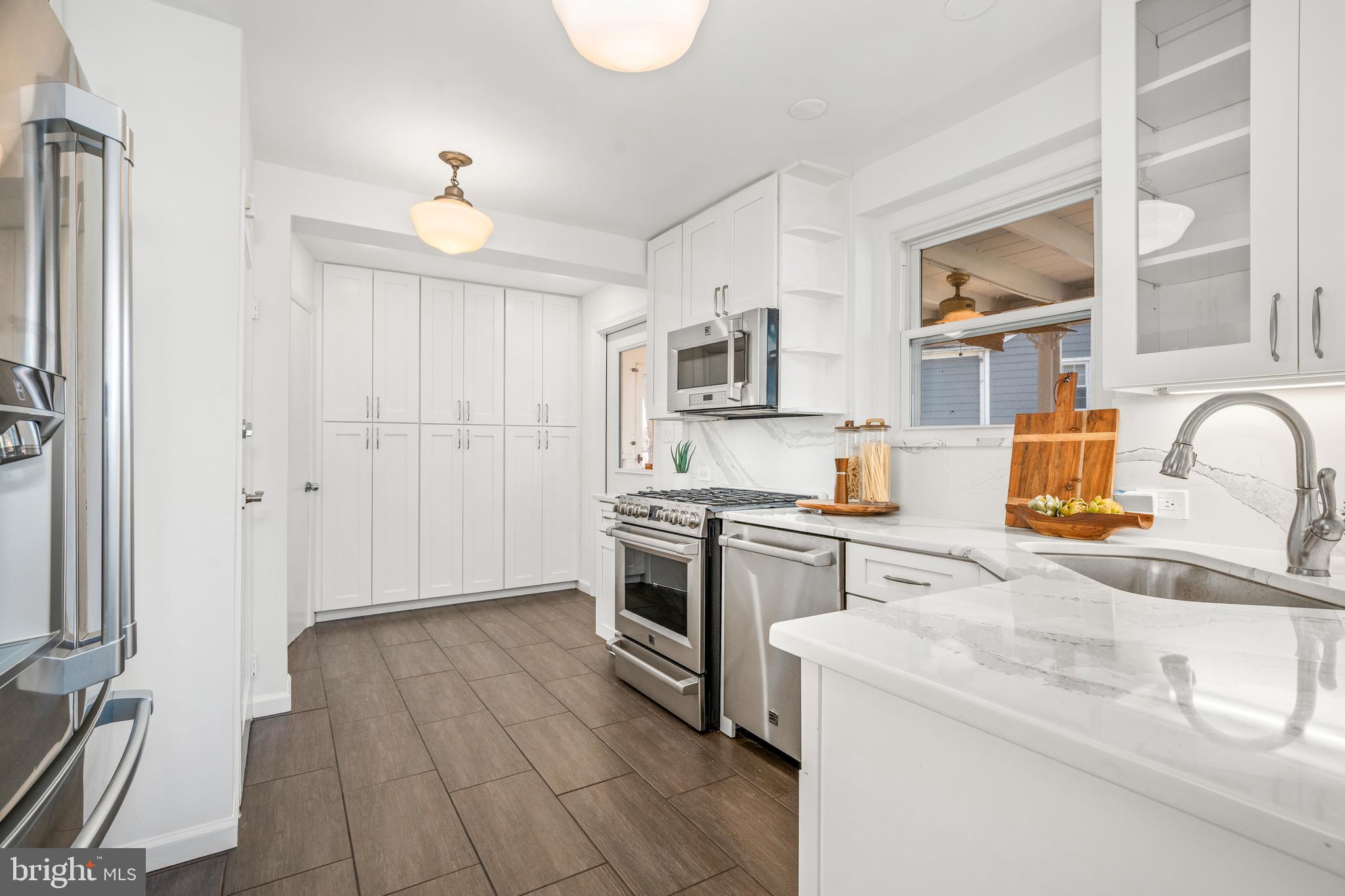 2700 Spencer Road Chevy Chase, MD 20815 - Photo 11 of 40 a kitchen with a sink appliances and cabinets