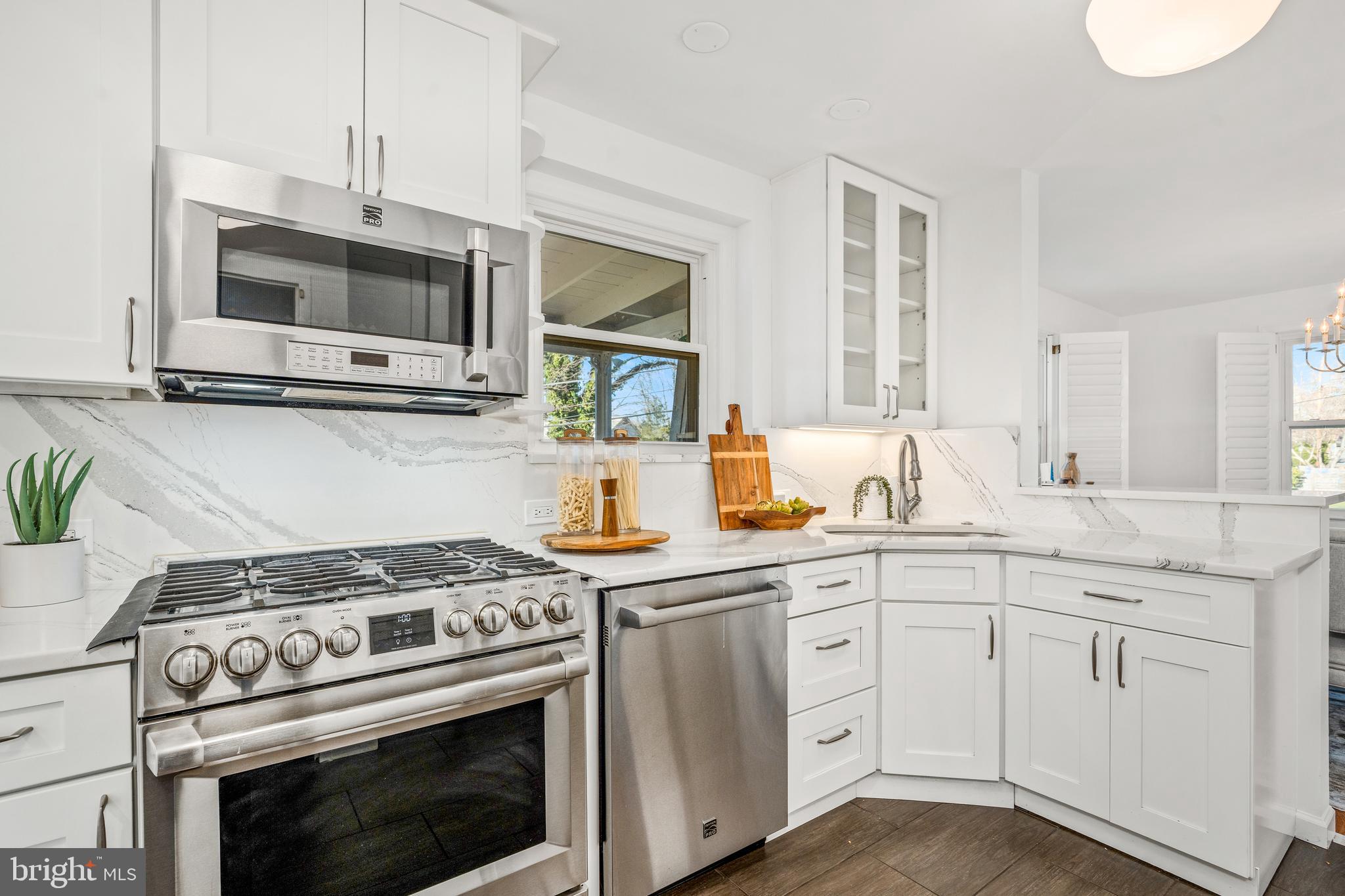 2700 Spencer Road Chevy Chase, MD 20815 - Photo 12 of 40 a kitchen with white cabinets and appliances