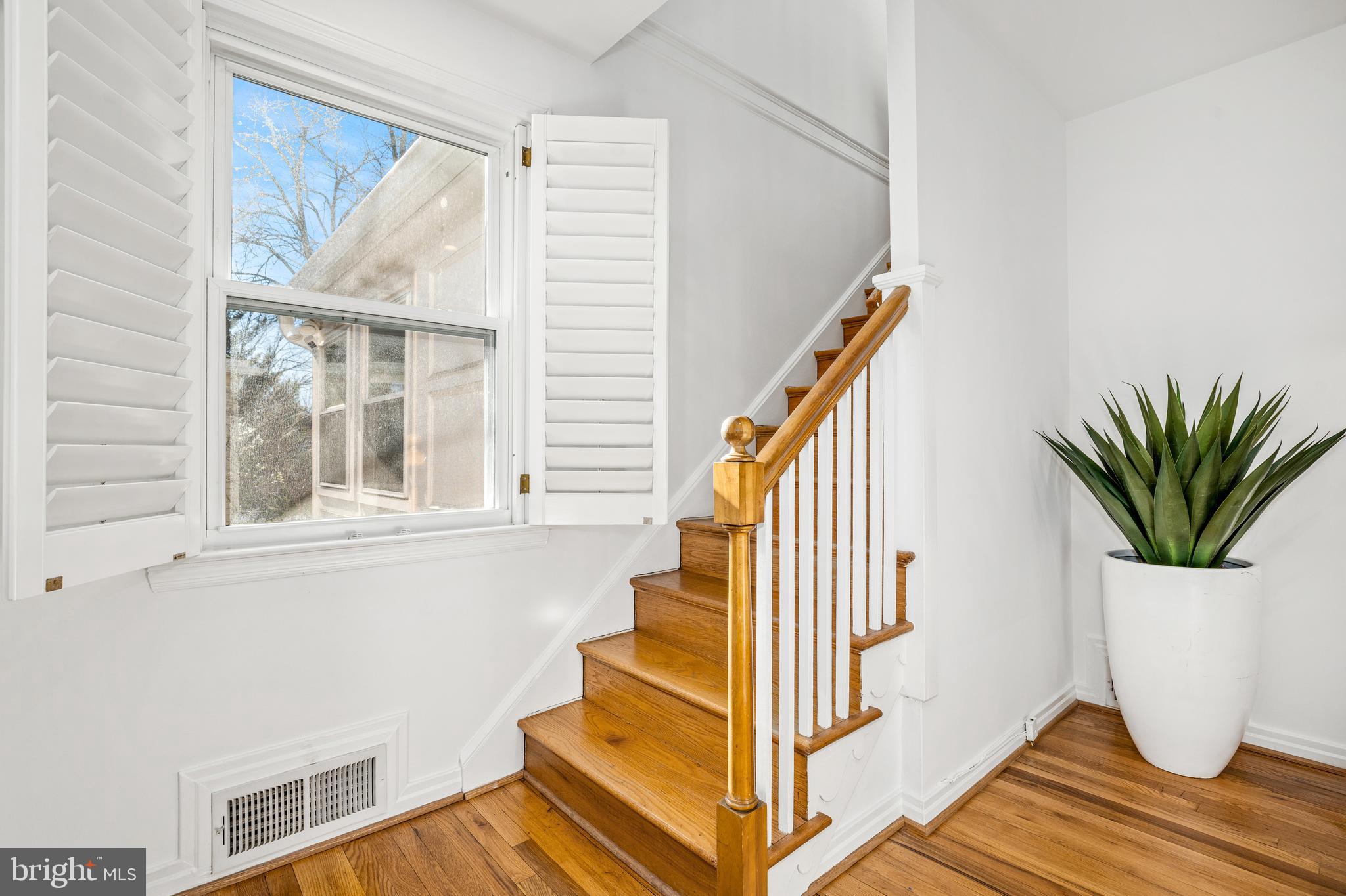 2700 Spencer Road Chevy Chase, MD 20815 - Photo 21 of 40 a view of staircase with wooden floor and a potted plant
