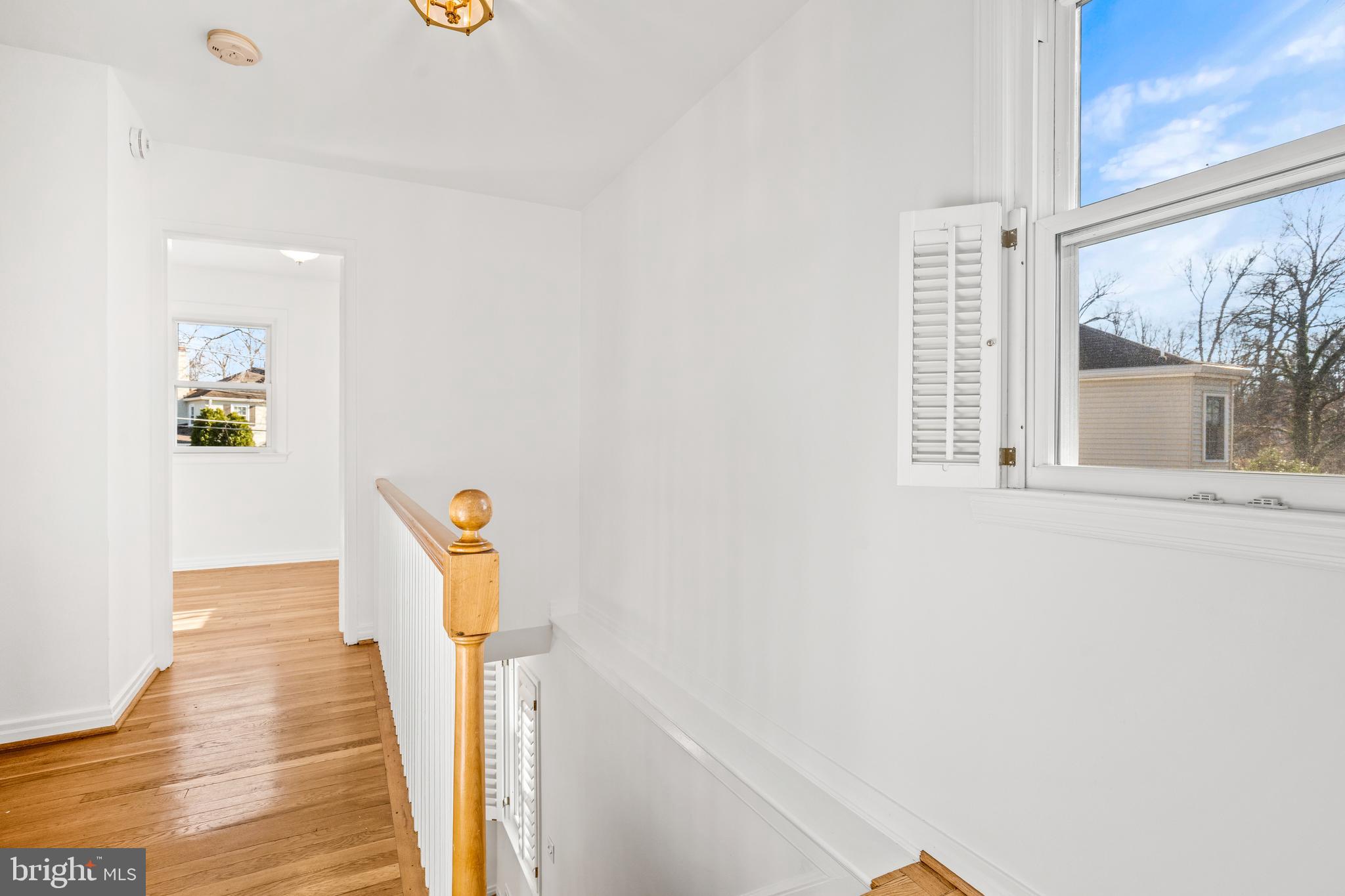 2700 Spencer Road Chevy Chase, MD 20815 - Photo 22 of 40 a view of a hallway with wooden floor and dining room