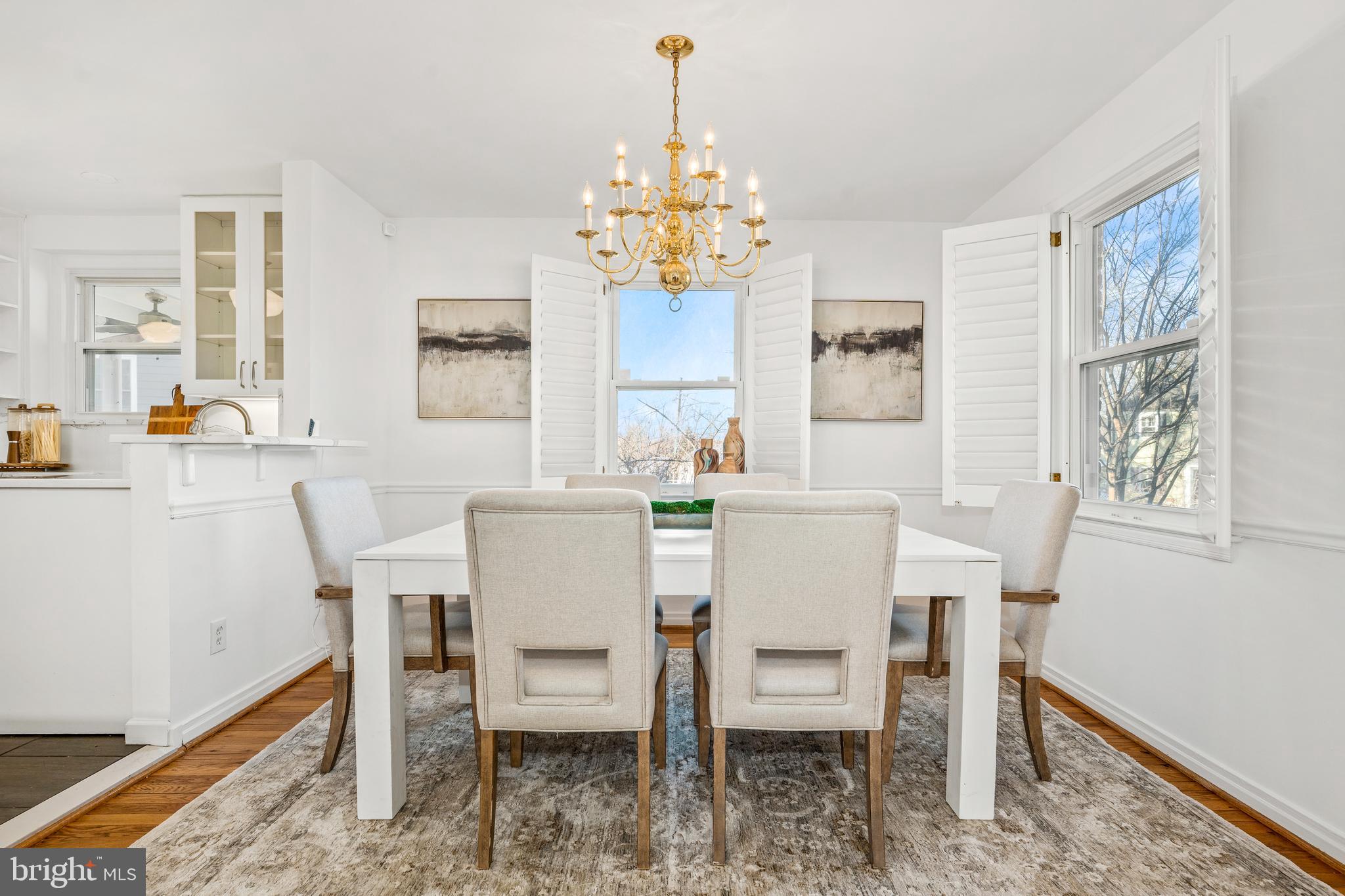 2700 Spencer Road Chevy Chase, MD 20815 - Photo 8 of 40 a view of a dining room with furniture a chandelier and wooden floor