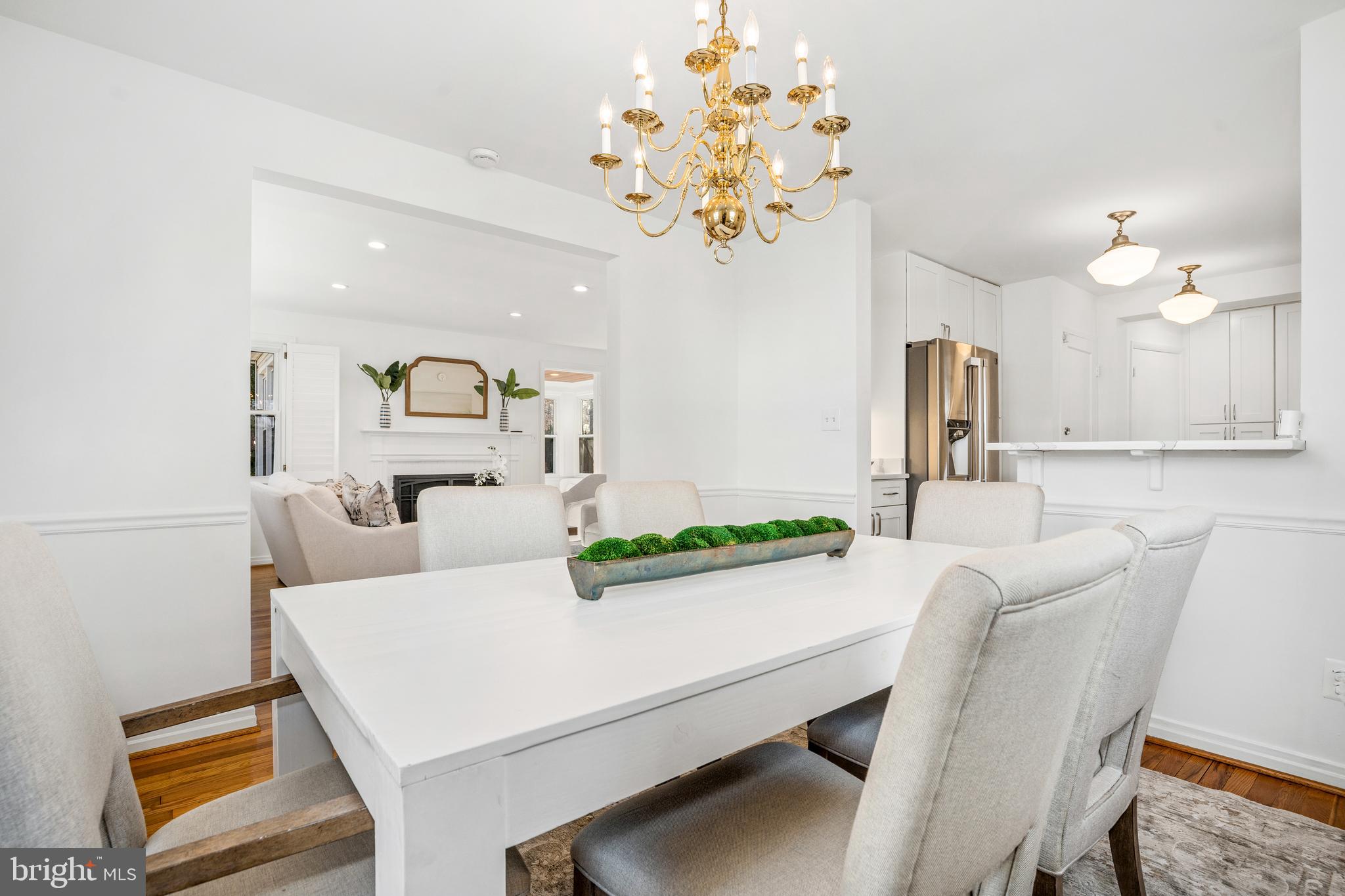 2700 Spencer Road Chevy Chase, MD 20815 - Photo 9 of 40 a view of a dining room with furniture and a chandelier