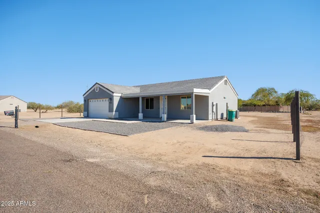 a front view of house with yard and garage