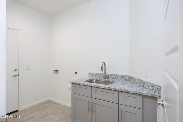 a bathroom with a granite countertop sink and mirror