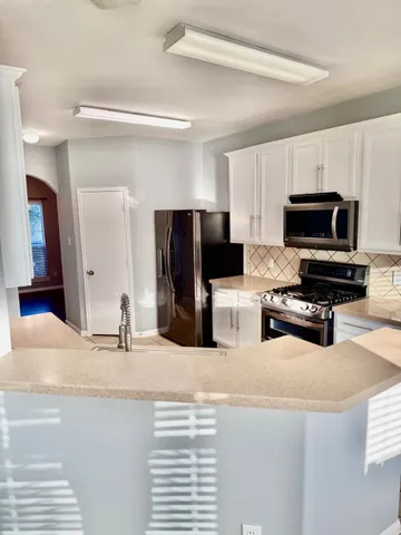 a kitchen with a refrigerator and a sink