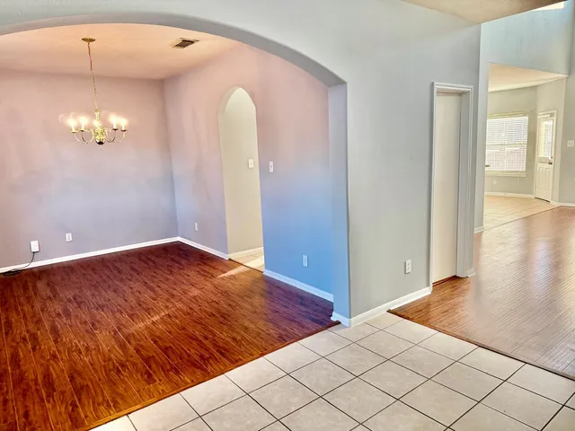 an empty room with wooden floor