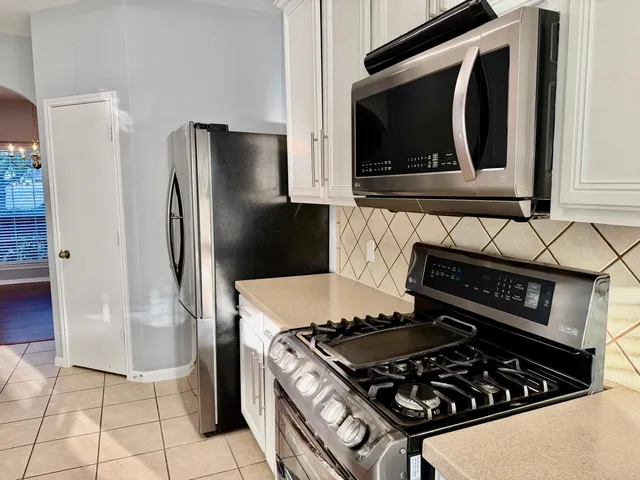a kitchen with a stove and a microwave
