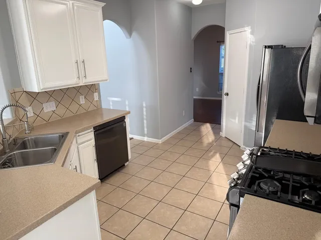 a kitchen with a refrigerator and a stove