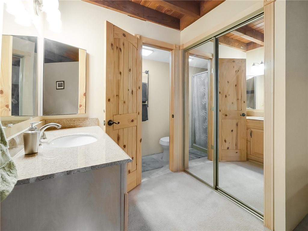 8100 Ryan Gulch Road, Unit E206 Silverthorne, CO 80498 - Photo 13 of 32 a spacious bathroom with a shower sink and mirror