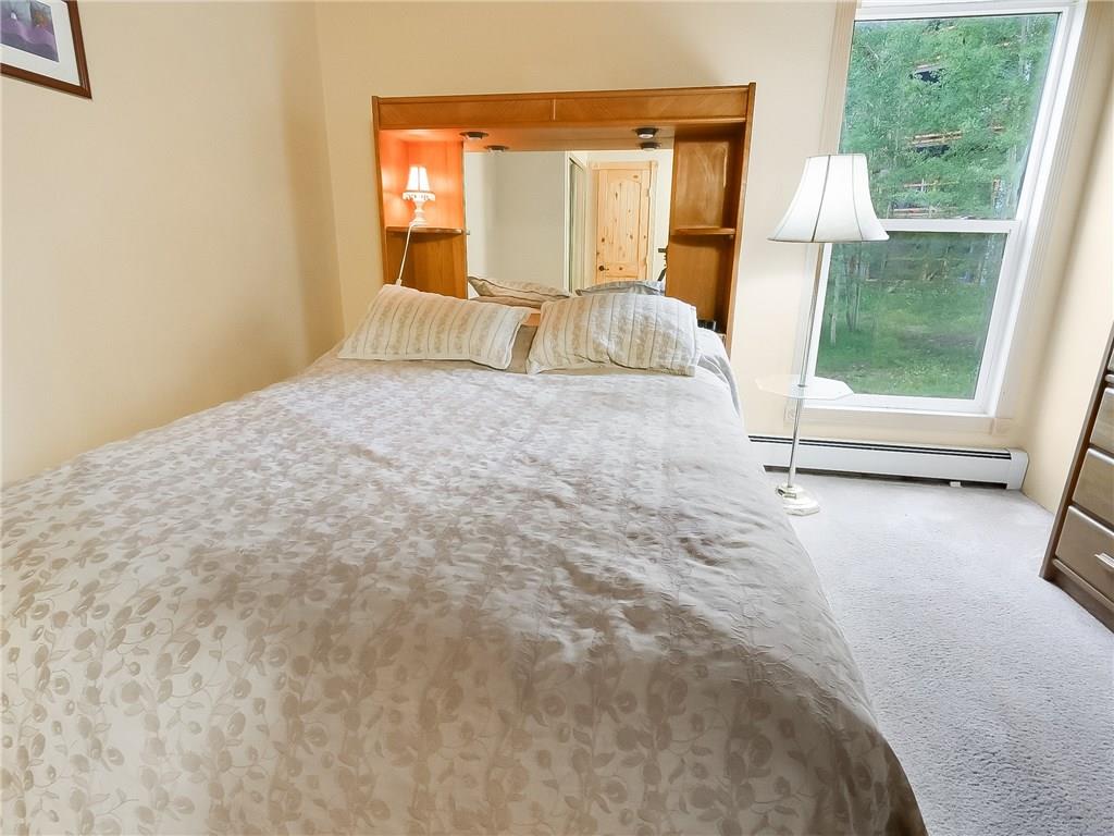 8100 Ryan Gulch Road, Unit E206 Silverthorne, CO 80498 - Photo 17 of 32 a view of empty room with wooden floor and fan