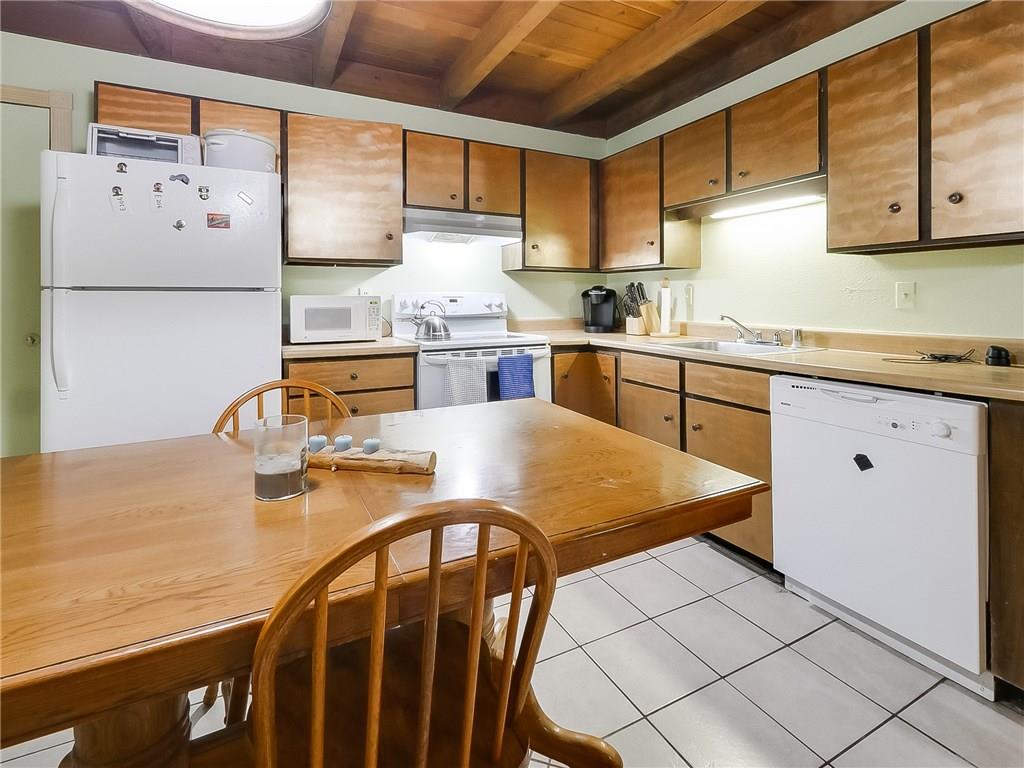 8100 Ryan Gulch Road, Unit E206 Silverthorne, CO 80498 - Photo 8 of 32 a kitchen with stainless steel appliances granite countertop a sink counter space and cabinets