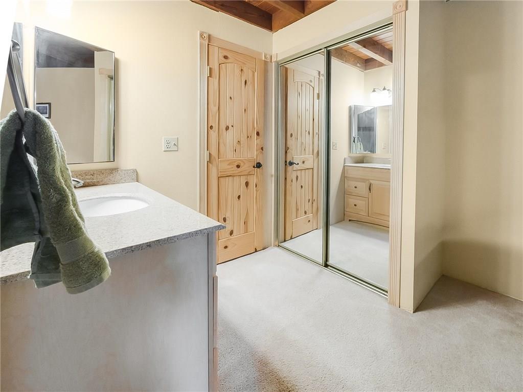 8100 Ryan Gulch Road, Unit E206 Silverthorne, CO 80498 - Photo 10 of 32 a bathroom with a tub sink and a mirror