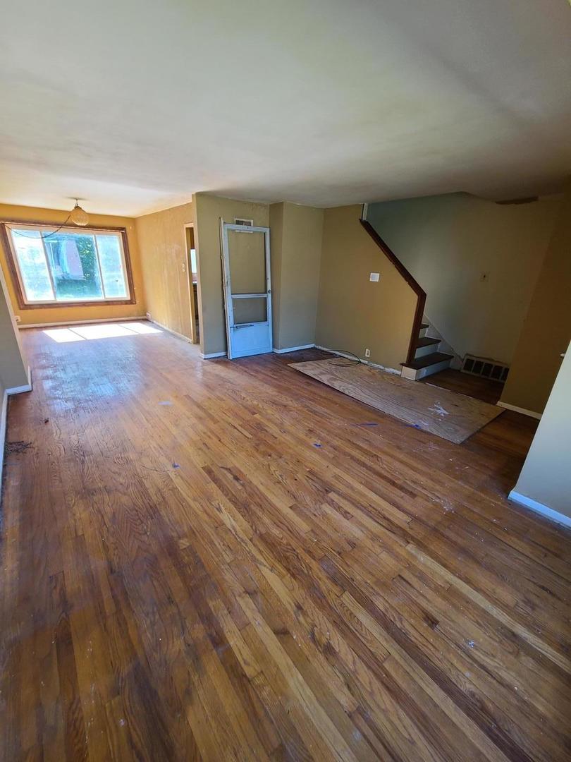 35 McGarity Road, Unit 772 Park Forest, IL 60466 - Photo 2 of 7 a view of an empty room with window and wooden floor