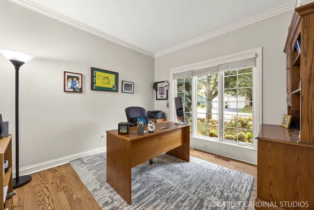 a view of a workspace with furniture and a window