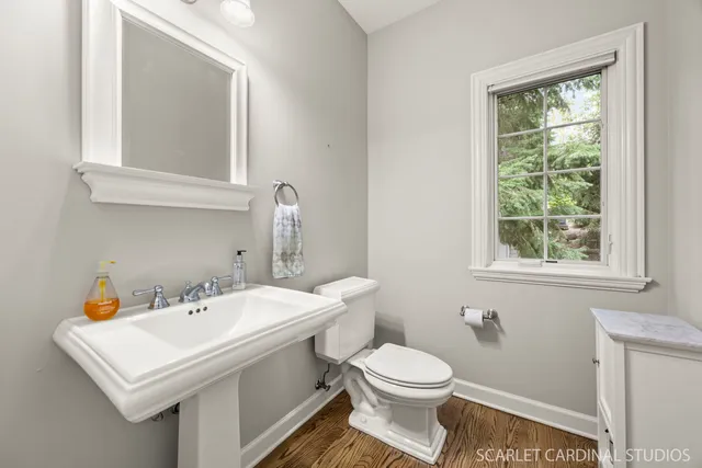 a bathroom with a sink a toilet and a mirror