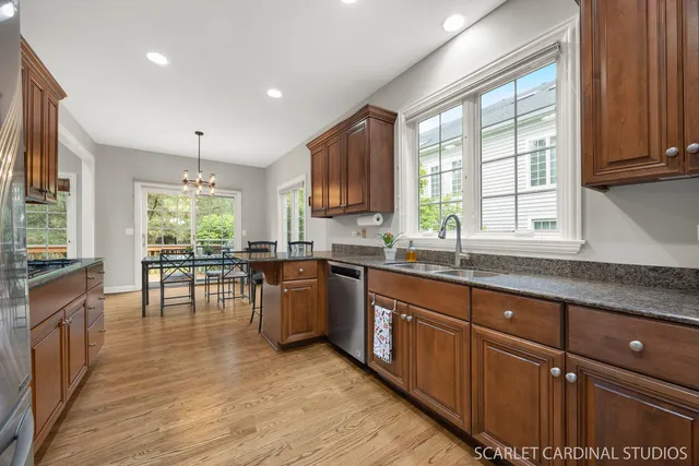 a kitchen with stainless steel appliances granite countertop wooden cabinets a sink and a stove