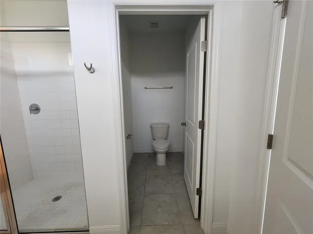 a bathroom with a glass door shower
