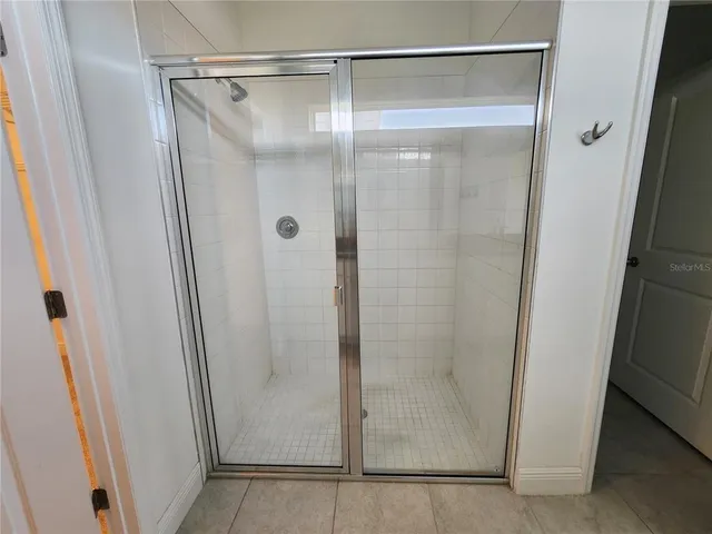 a bathroom with a glass shower door