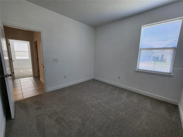 a bathroom with a granite countertop sink mirror vanity and toilet