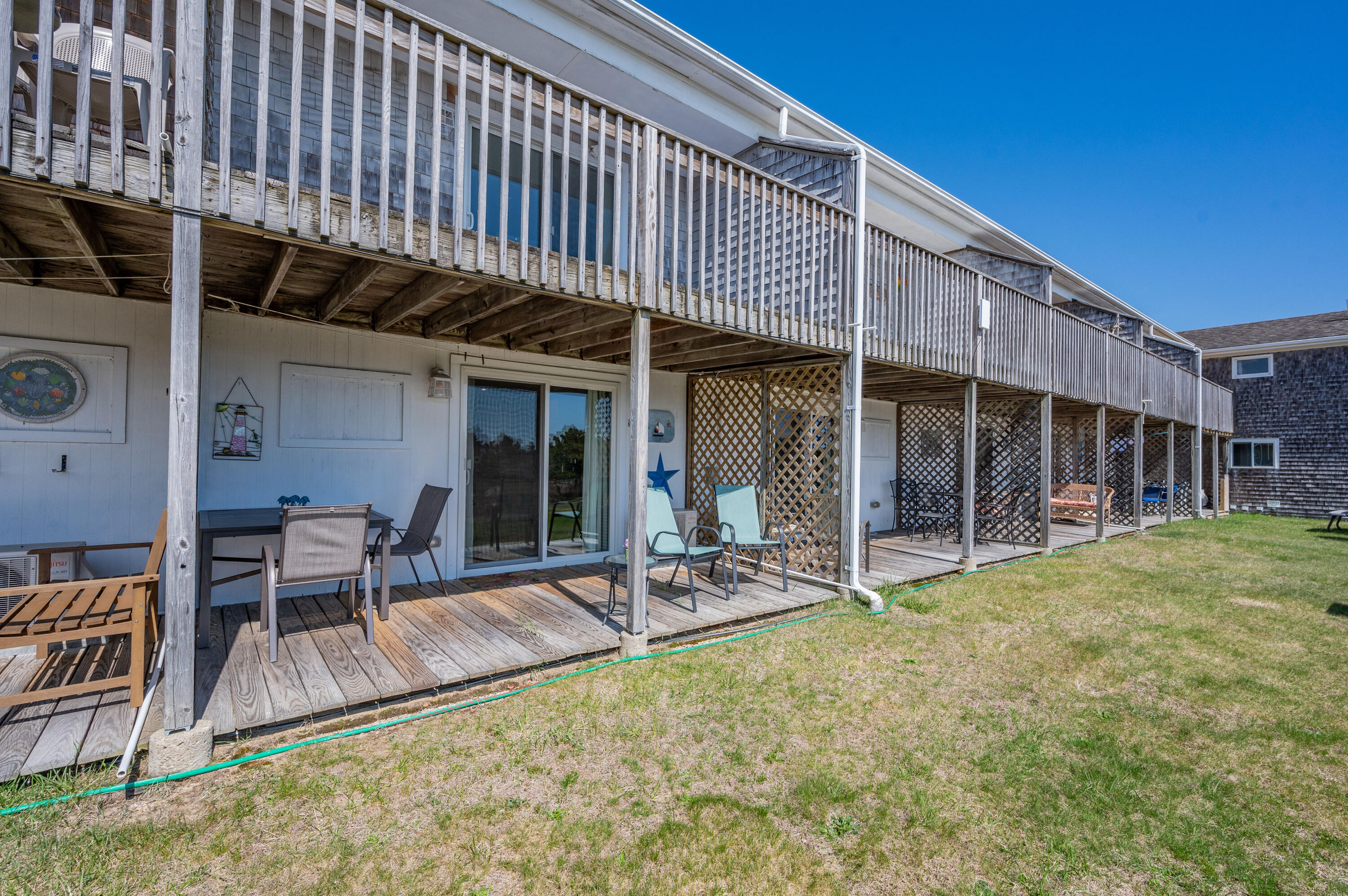 132 Shore Road, Unit 9 Truro, MA 02666 - Photo 23 of 28 a view of a house with backyard porch and sitting area