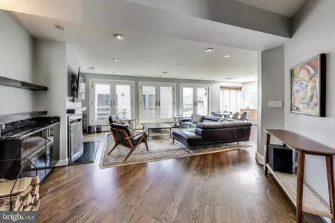 a living room with furniture and a wooden floor