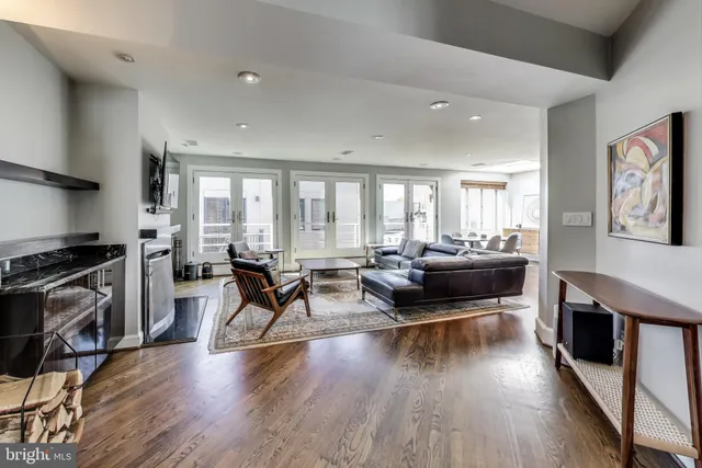 a living room with furniture and a wooden floor