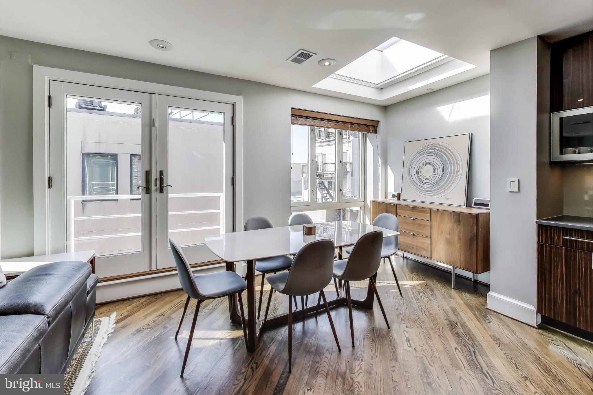 2370 Champlain Street Northwest, Unit 34 Washington, DC 20009 - Photo 8 of 33 a view of a dining room with furniture window and wooden floor