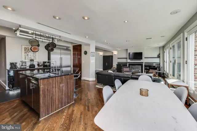 a kitchen with a sink appliances and cabinets