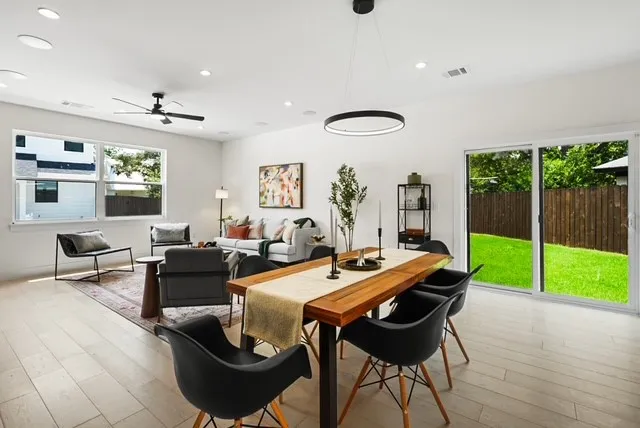 a view of a dining room with furniture wooden floor and chandelier