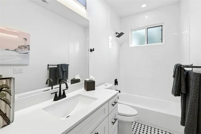 a bathroom with a sink a toilet and a tub